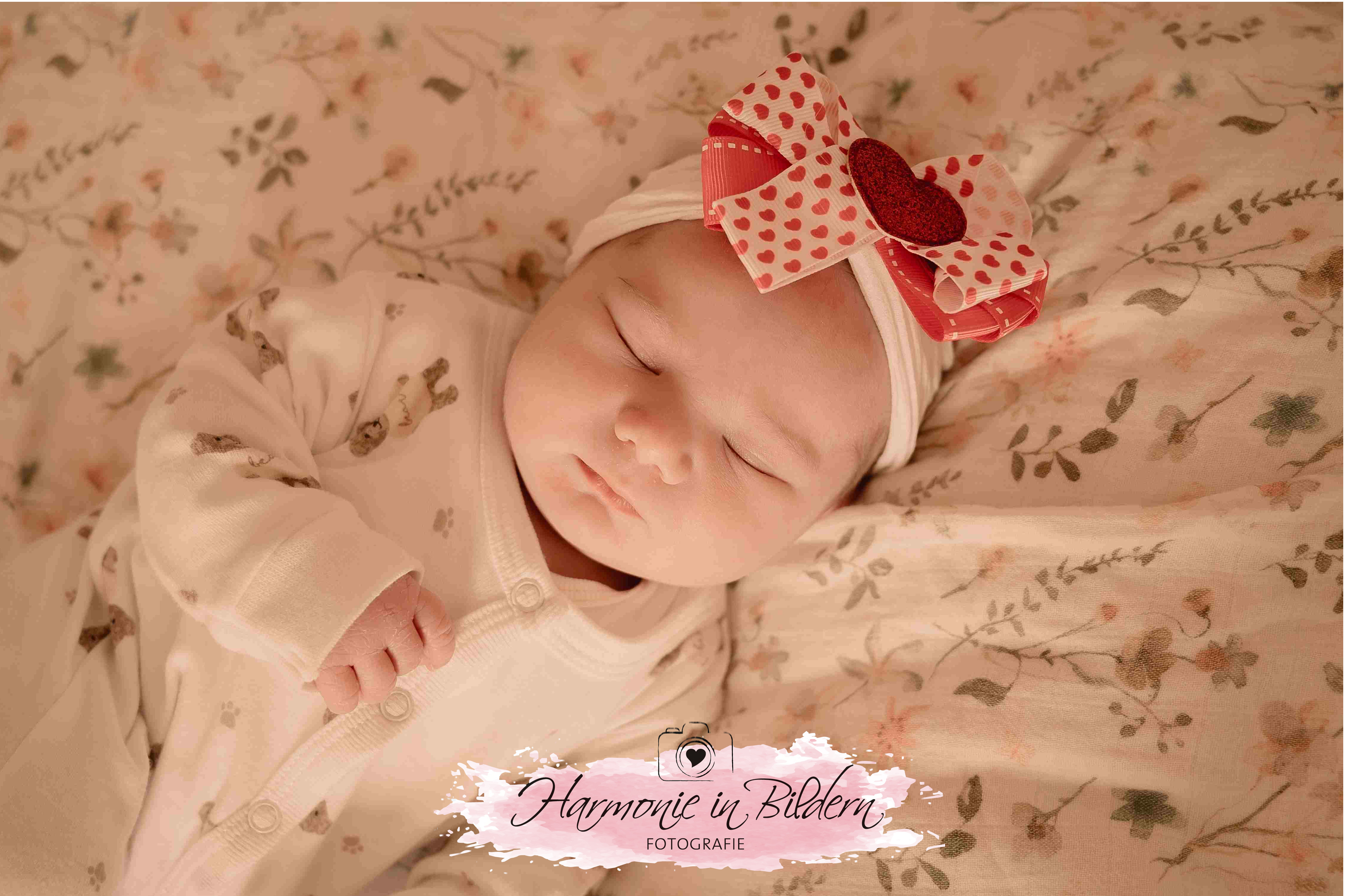 Neugeborenes Mädchen mit Roter Haarschleife