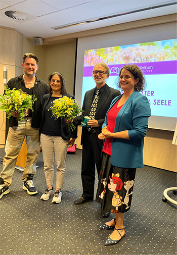 Mehrere Personen halten einen Blumenstrauss in den Händen.